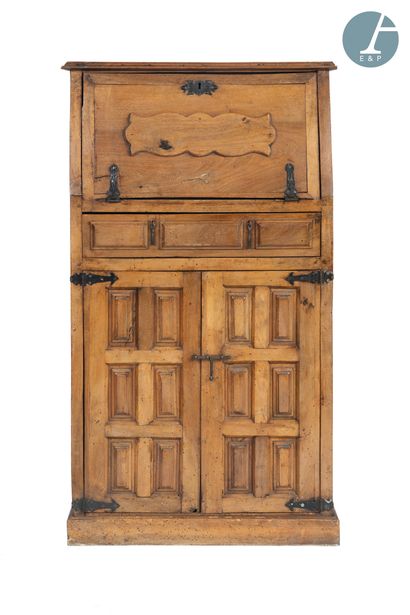 null 
Secretary in natural wood molded and carved opening with a flap, a drawer and...