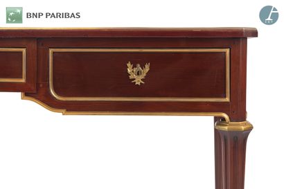 null Mahogany flat desk opening to three drawers and resting on tapered legs with...