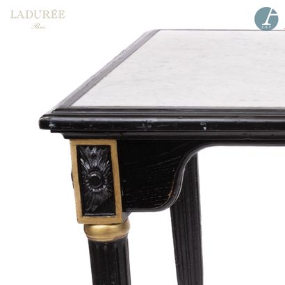 null From the Maison Ladurée - Library

A large molded and carved wood table, black...