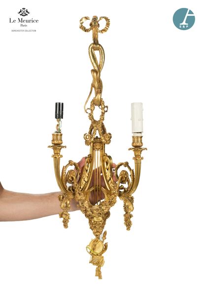 null From the Hôtel Le Meurice.
A pair of two-light sconces in chased and gilded...