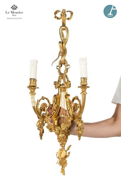 null From the Hôtel Le Meurice.
A pair of two-light sconces in chased and gilded...