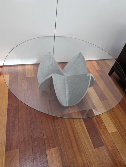 null Brutalist glass table, grey cement base, sand rose shape, circular glass top.
H:...