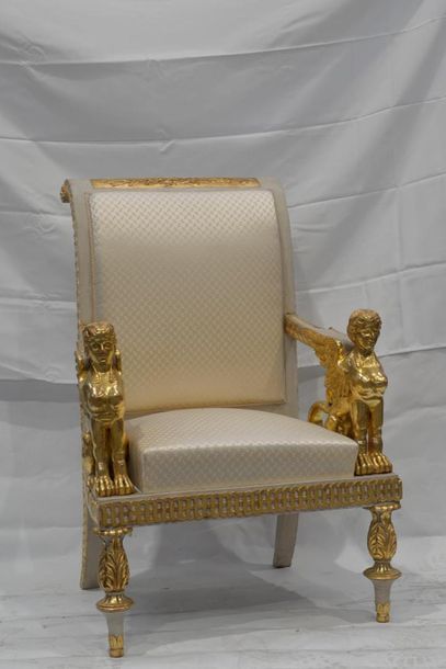 null IMPORTANT FABRIC in painted and gilded wood, the armrests in the shape of winged...