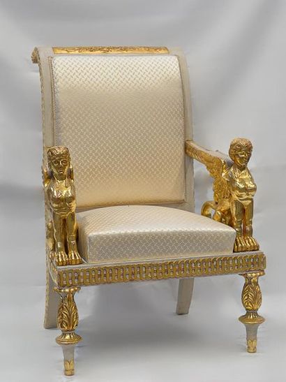 null IMPORTANT FABRIC in painted and gilded wood, the armrests in the shape of winged...