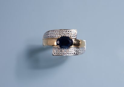 null RING in 18 ct yellow gold set with a dark oval sapphire of about 1 ct framed...