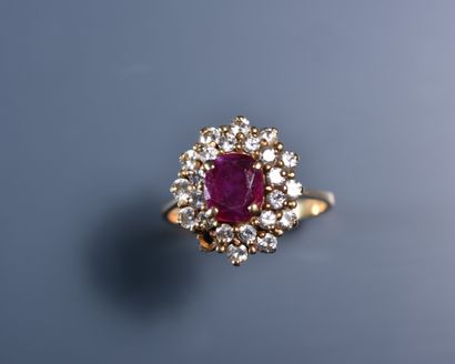 null Gold MARGUERITE ring set with a ruby surrounded by a double row of small brilliants,...
