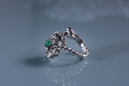 null White gold ring with twisted ring and set with a small emerald surrounded by...
