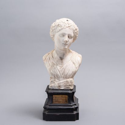 null A white marble bust of Diana in the antique style on a blackened wood base....