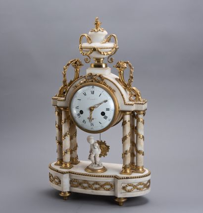 null A gilt bronze and white marble temple clock with four doric columns resting...