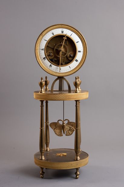 null Gilt bronze skeleton clock. The enamelled dial with Roman numerals shows the...
