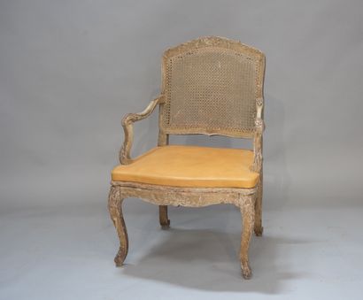 null Moulded and carved wood armchair, seat and back caned. Recessed armrests. Stamped...