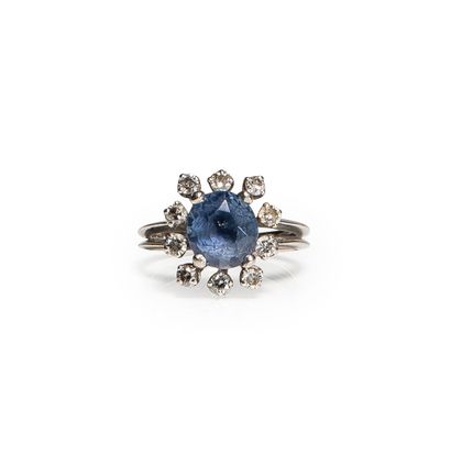 null RING in 18 ct white gold set with a clear sapphire surrounded by small diamonds....