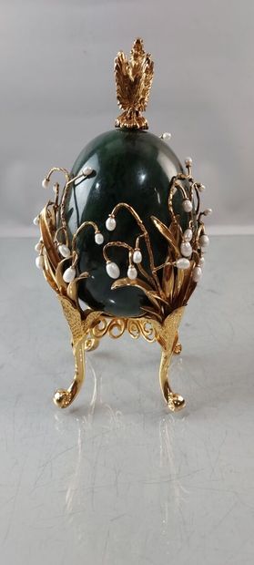 null In the taste of FABERGE EGG in green hard stone, surrounded by scrolls of gold-plated...