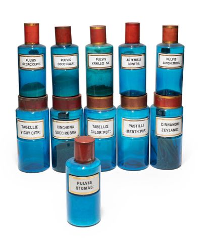 null ELEVEN PHARMACY POTS in blue tinted glass, porcelain labels. H. : 24 and 27.5...