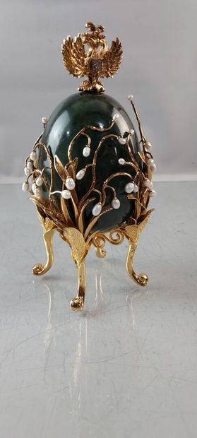 null In the taste of FABERGE EGG in green hard stone, surrounded by scrolls of gold-plated...