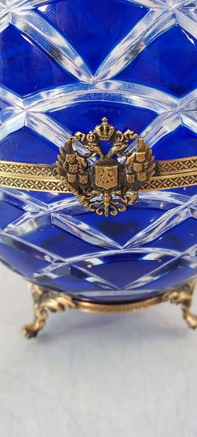null FABERGE FRANCE, EGG in blue cut crystal of ovoid form and bronze mounting, the...