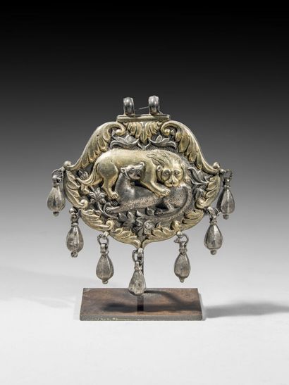 null Gilded silver pendant showing a lion devouring its prey. 

Central Asia or...