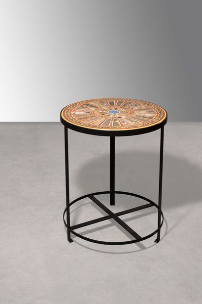 null Iron pedestal table topped by a round tray of colored marble inlay

the tray...