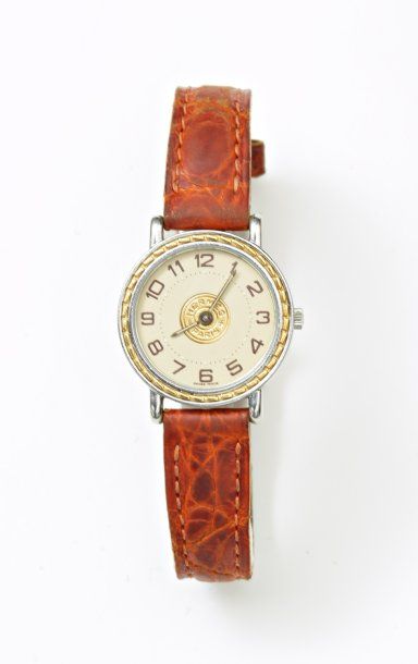 HERMES bracelet montre de dame, ronde, en acier et métal doré, modèle "Sellier"....