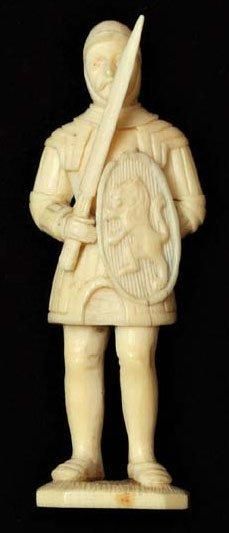 null SUJET en ivoire représentant un chevalier portant un écu sculpté d'un lion....