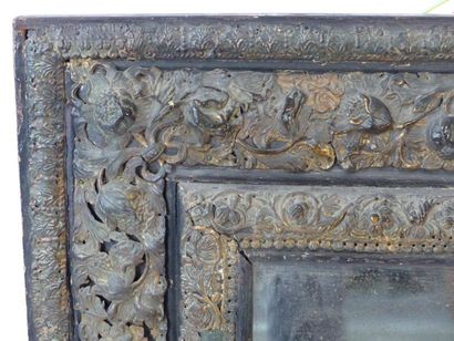 Miroir Louis XIII. Miroir quadrangulaire à riche décor de feuillages au repoussé....