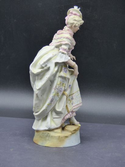 Sujet en biscuit. Bisque subject representing a woman holding her dress. Height :...