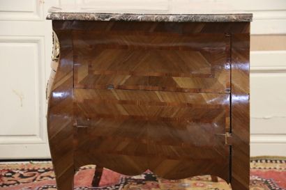 null Wooden chest of drawers inlaid with frames, curved on all sides. It opens with...