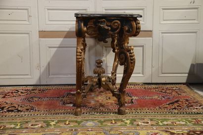 null Baroque console in carved and gilded wood, richly decorated with winged shells...