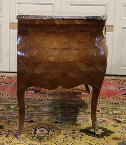 null Wooden chest of drawers inlaid with frames, curved on all sides. It opens with...