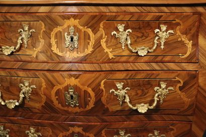 null Louis XV period. Attributed to COULERU. A plum and walnut veneered curved chest...
