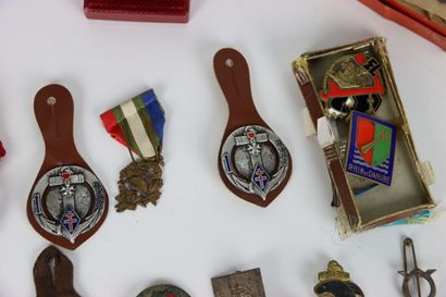null In a wooden box. More than fifty regimental badges and some decorations, including...