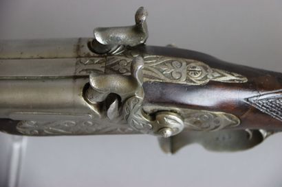 null A double barrel shotgun with table and percussion, engraved plates in high relief,...