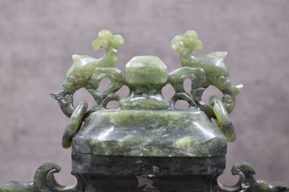 CHINE. Perfume burner in carved stone of nephrite type, openwork handles, fish-shaped...