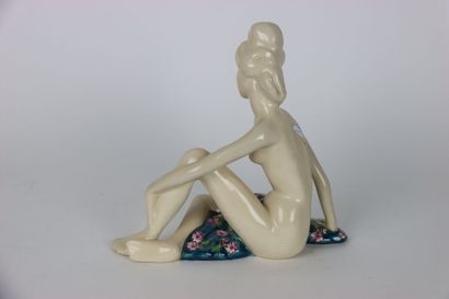 null Large ceramic in crackle and polychrome enamels representing a young woman sitting....