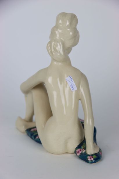 null Large ceramic in crackle and polychrome enamels representing a young woman sitting....