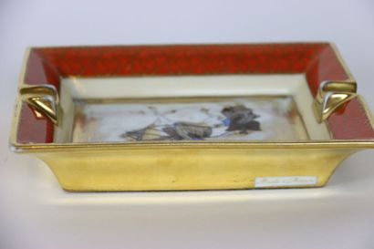 null HERMES. Porcelain ashtray decorated with a Japanese rider on a gold background....