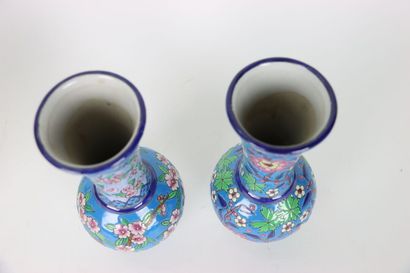 null Pair of enameled porcelain vases with floral decoration on a blue background,...