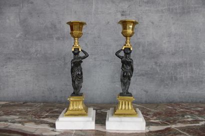 Paire de flambeaux Paire de flambeaux en bronze ciselé, doré et patiné, à décor d'athénienne...