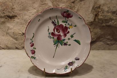 null APREY, 18th century. Plate in enamelled earthenware with floral decoration and...