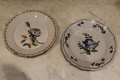 null Two enamelled earthenware plates of the 18th century, with floral decoration...