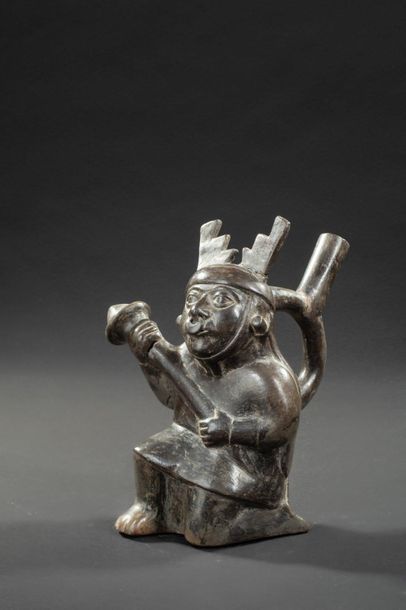 null Vase with a stirrup-shaped handle representing a warrior

He's kneeling and...