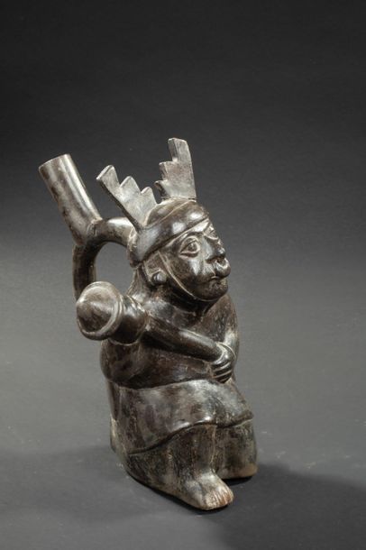 null Vase with a stirrup-shaped handle representing a warrior

He's kneeling and...