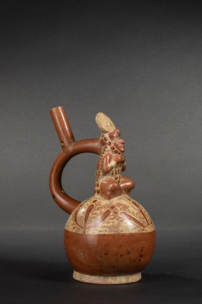 null Vase with stirrup-shaped handle and ceremonial decoration

A shaman sits, wearing...