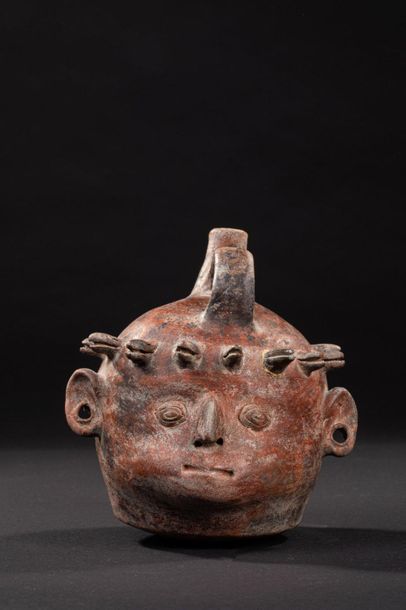 null Anthropomorphic vase representing a human face with a nose is aquiline. A crown...