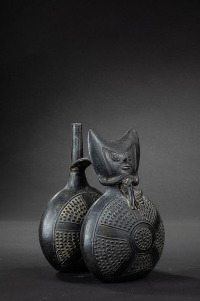 null Vase with double belly and flat handle. On the first flattened belly sits a...