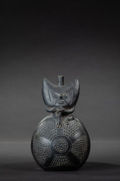 null Vase with double belly and flat handle. On the first flattened belly sits a...