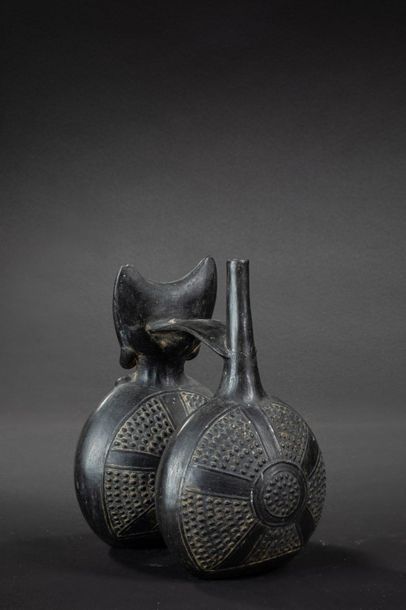 null Vase with double belly and flat handle. On the first flattened belly sits a...