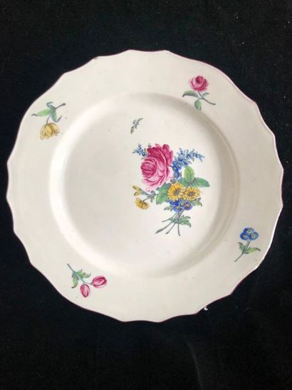 null TOURNAI Soft paste plate with contoured rim, polychrome decoration of a bouquet...