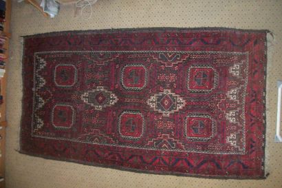 null Belushistan carpet, brown or olive green background, decorated with medallions...