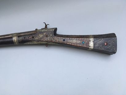 null Afghan flintlock rifle called Tufek.

burr walnut wood inlaid with brass wire...